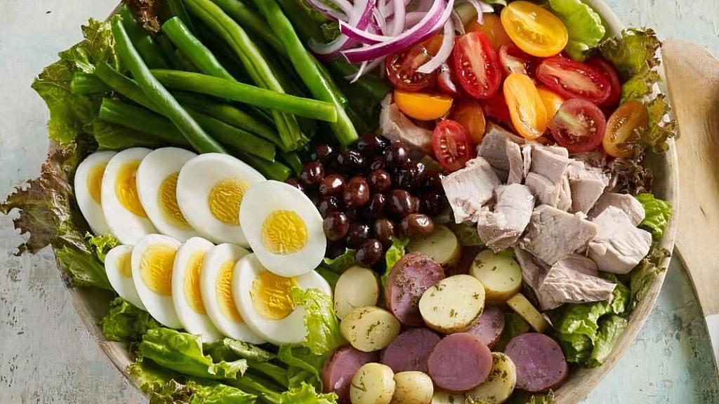Tuna Nicoise Salad · Spring mix, tuna chunks, sliced eggs, nicoise black olives, potatoes,  cherry tomatoes,  and vinaigrette