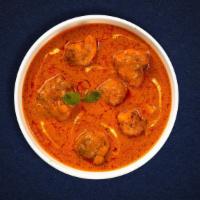 Old Delhi Butter Chicken · Grilled chunks of chicken cooked in a classic tomato gravy with butter and cream.