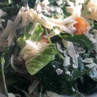 Kale Caesar Salad · Baby kale, romaine, capers, croutons, anchovy dressing, shaved parmesan.