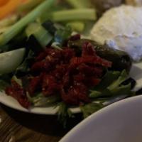 Mediterranean Sampler · Hummus, tzatziki & roasted eggplant salad, stuffed grape leaves, grilled pita & veggies.