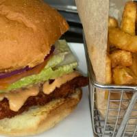 Buttermilk Fried Chicken Sandwich · Chicken thigh (dark meat), sriracha aioli, dill pickles, lettuce, tomato, onion, brioche bun.