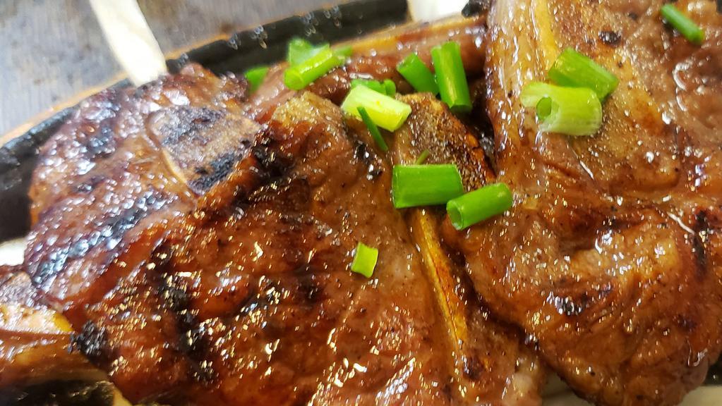 엘에이갈비 / Galbi · BBQ beef short ribs marinated with soy sauce based our signature sauce. Served with kimchi, ban chan (Vegetables) and white rice.