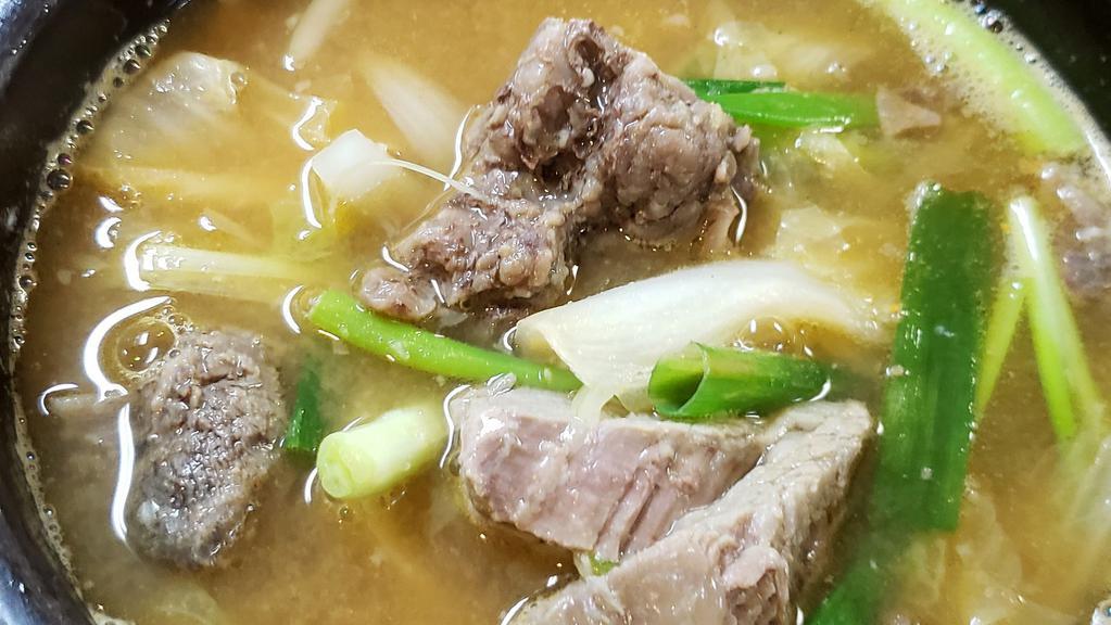 우거지갈비탕 / Short Rib And Cabbage Soup · Ugeoji galbitang / Tender beef short ribs and cabbage soup. Served with kimchi, ban chan (Vegetables) and white rice.