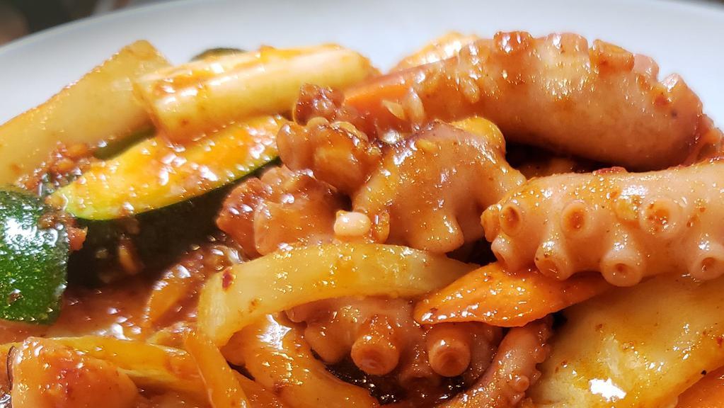 낙지볶음 / Stir-Fried Octopus · Nakji Bok eum / Stir-fried octopus and vegetables with spicy sauce. Served with kimchi, ban chan (Vegetables) and white rice.