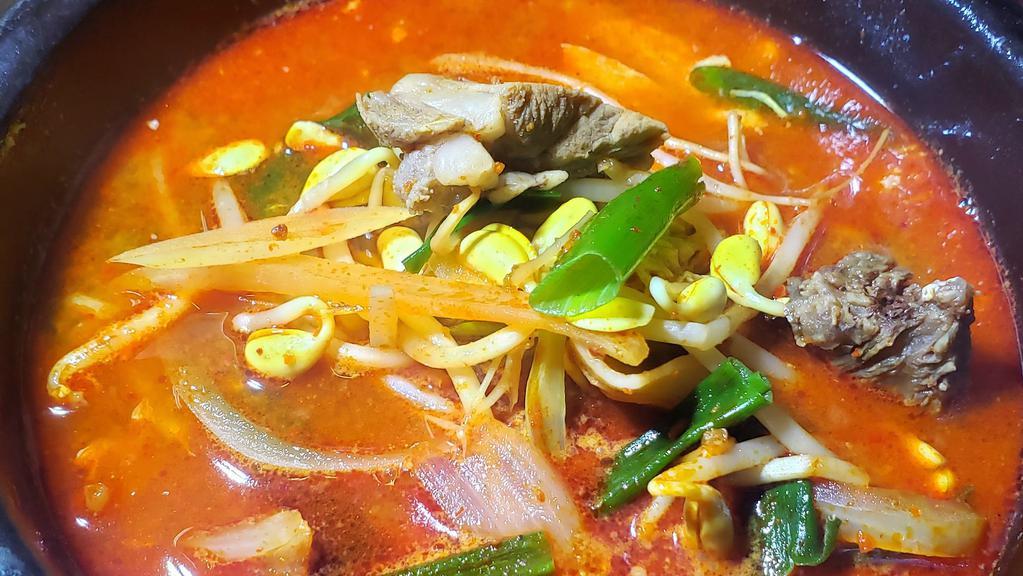 국밥 / Guk Bap · Tender beef and assorted vegetables in spicy egg drop soup. Served with kimchi, ban chan (Vegetables) and white rice.