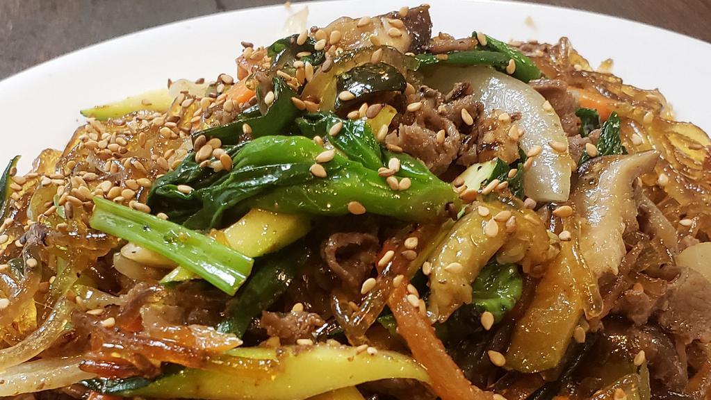 Japchae /  잡채 · Stir-fried sweet potato glass noodles in sesame oil and soy sauce with a variety of vegetables with beef.