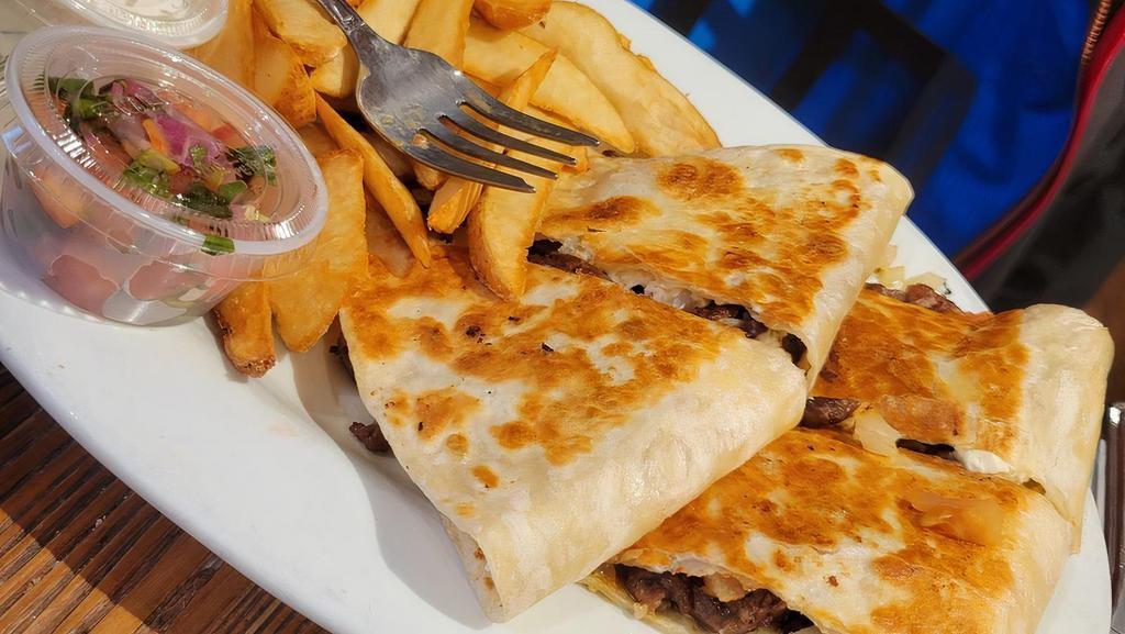 Gyro Quesadilla · Flour tortilla grilled filled with gyro, sautéed onions, tomatoes, feta cheese. Served with tzatziki sauce.