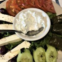 Greek Salad · With olives, anchovies, and Feta Cheese on a bed of greens.