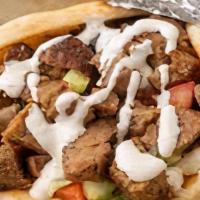 Lamb Gyro Wrap · Chunks of Lamb in Gyro bread with Lettuce, Tomato, Onion, Green peppers & Gyro sauce