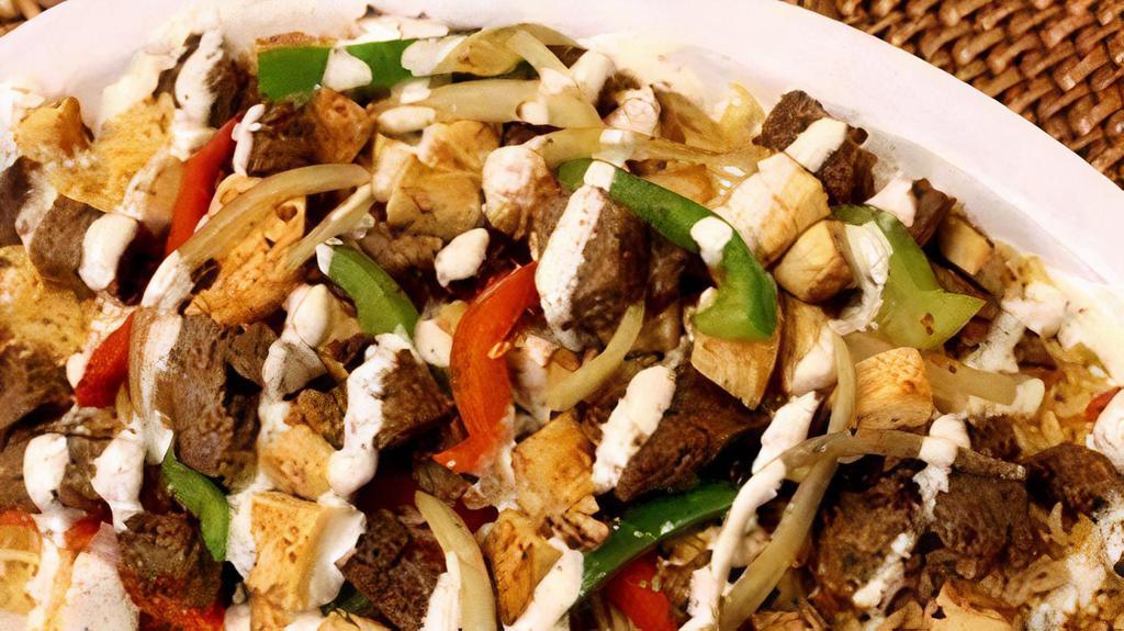 Lamb Gyro Over Rice · Chunks of Lamb on Rice with Lettuce, Tomato, Onion, Green peppers & Gyro sauce