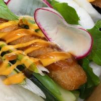 Crispy Fish Bun · Steamed buns, fried fillet catfish, mixed green, cucumber, radishes, scallion, spicy mayo sa...