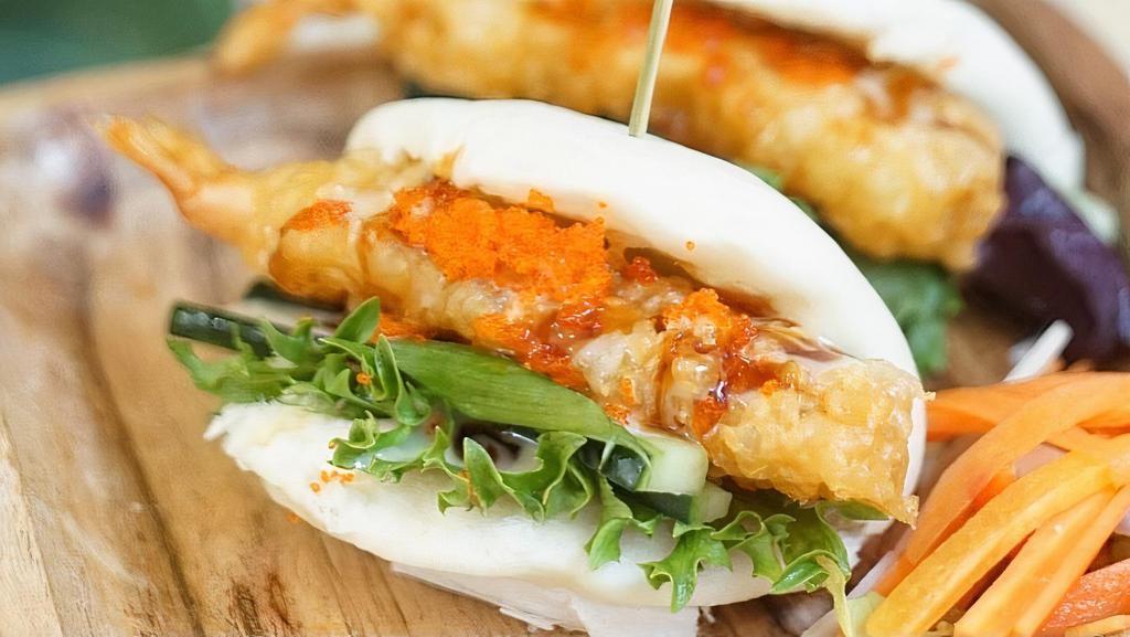 Ebi Tempura Bun · Steamed buns, fried shrimp tempura, mixed green, cucumber, scallion, seafood mayo sauce, teriyaki sauce, topped with tobiko.