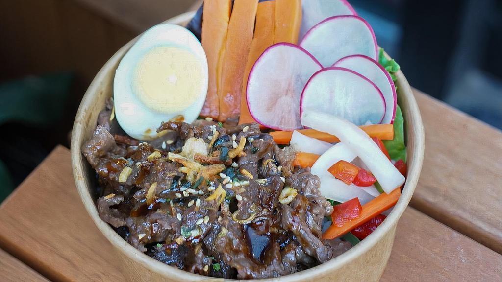 Bulgogi Bowl · Jasmine rice, beef bulgogi, cucumber, carrot, scallion, pickle, boiled egg, seaweed seasoning, eel sauce, fried shallot.