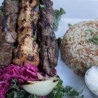 Ouche Mixed Grill Platter · One skewer of beef shish kabob, chicken shish, and kafta kabob served with rice pilaf and on...