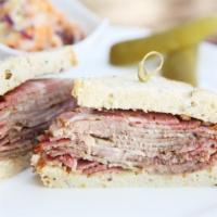 The Buski Sandwich · Delicious pastrami, corned beef, Swiss cheese, coleslaw and Russian dressing.