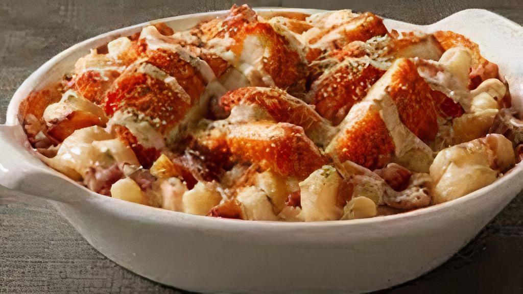 Buffalo Chicken Mac · Crispy chicken tossed in buffalo sauce on top of noodles with housemade cheese sauce.