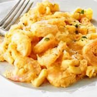 Spicy Shrimp Mac · Sauteed shrimp tossed in sriracha sauce on top of noodles with housemade cheese sauce.
