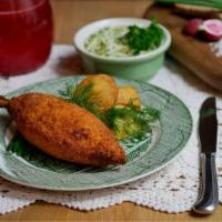 Traditional Chicken Kiev · Stuffed with herb butter, served with mashed potatoes.