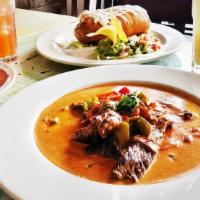 Puntas Al Chipotle · Sliced hanger steak in Chipotle-cream sauce with onions, red and green peppers. Served with ...