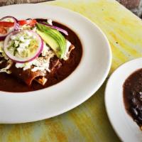 Mole Poblano · Chicken in Mole Poblanos sauce. Served with black beans, yellow rice, or salad.