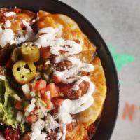 Chorizo Nachos · Tasty Mexican sausage. Topped with melted cheese, black beans, and sour cream. Jalapeños, Pi...