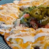 Cheese Nachos · Melted blended cheeses, black beans, and sour cream. Jalapeños, Pico de Gallo, and Guacamole...