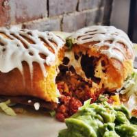 Chicken Chimichanga · Fried burrito filled with yellow rice, cheese, and sour cream. Served with guacamole and pic...