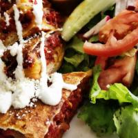 Chicken Quesadilla · Flour tortilla filled with grilled chicken and melted cheese. Topped with sour cream and Cot...