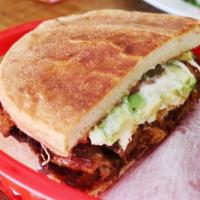 Chicken Torta · Mexican sandwich with chicken, black beans, Oaxaca cheese, avocado, tomatoes, and jalapeños.