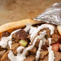 Lamb Gyro Wrap · Chunks of lamb in gyro bread with lettuce, tomato, onion, green peppers & gyro sauce.
