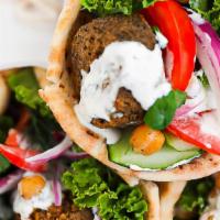Falafel Gyro Wrap (Vegetarian) · Chunks of falafel in gyro bread with lettuce, tomato, onion, green peppers & gyro sauce.