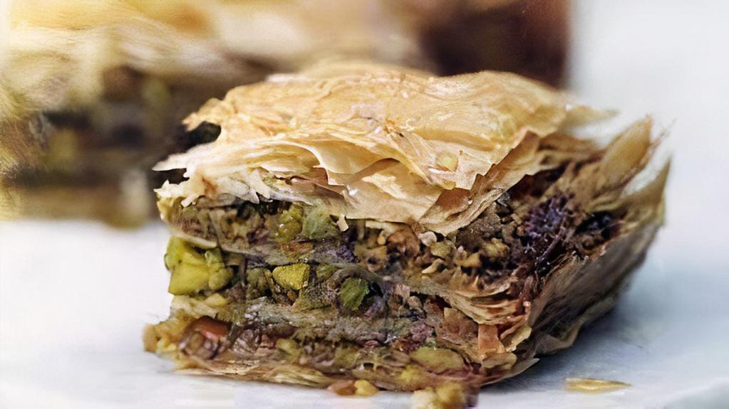 Baklava · Flaky phyllo dough layered with cinnamon and chopped nuts, bathed in house-made syrup.
