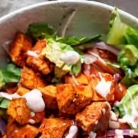 Buffalo Blue Chicken Salad · Lightly fried chicken tenders tossed in buffalo sauce over romaine and iceberg lettuce, in c...