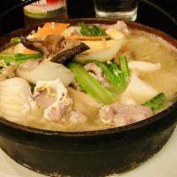 Clay Pot Noodles · Homestyle crispy noodles with vegetables, pork, shrimp and squid with egg gravy in a clay pot.