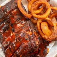 Smoked Baby Back Ribs · Our famous smoked baby back ribs slowly cooked over hickory wood. Make it a platter: include...