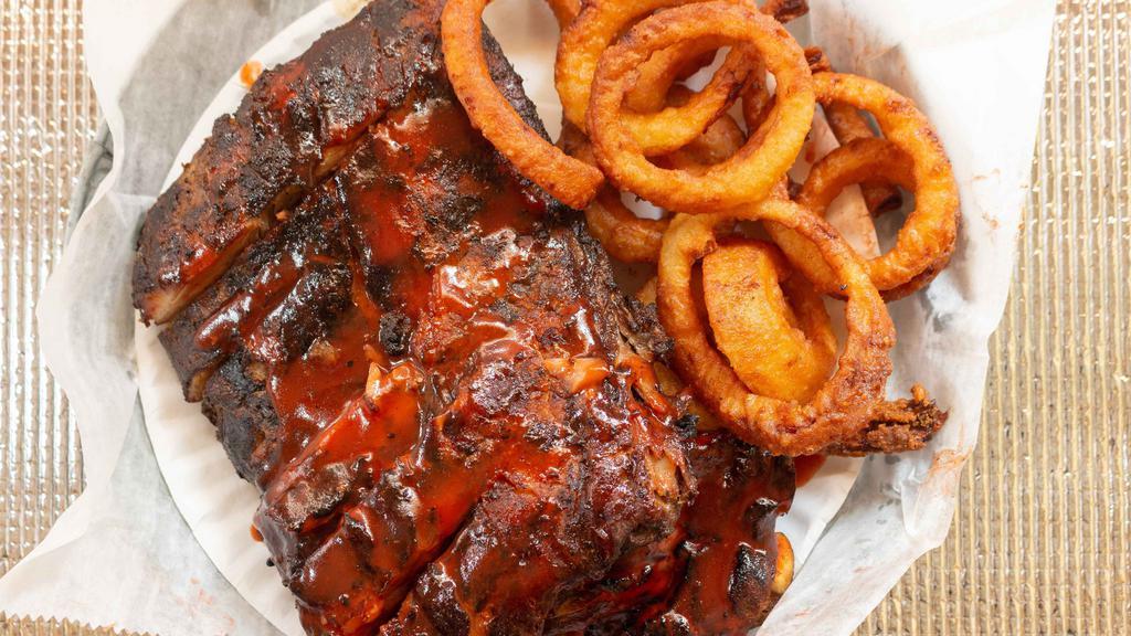 Smoked Baby Back Ribs · Our famous smoked baby back ribs slowly cooked over hickory wood. Make it a platter: include fries and slaw for additional cost.