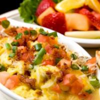 Dawn Breaker · Eggs scrambled with mushrooms and bacon. Top it with melted Jack and cheddar cheese, tomatoe...