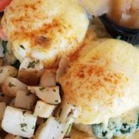 Lobster Benedict · A pair of poached eggs on top of rich lobster with sautéed spinach. All on a toasted English...