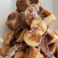 Banana Fosters Waffle · Fresh bananas sautéed in cinnamon, brown sugar and butter and poured over a crispy Belgian w...