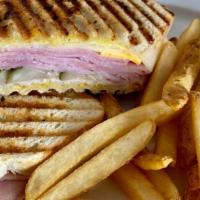 Le Cuban Panini · Turkey, Ham, swiss cheese, honey mustard and pickles. Served with choice of soup, salad or f...