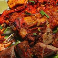 Tandoori Mix Grill · A combination platter consisting of chicken tandoori, chicken tikka, lamb tikka, salmon tikk...