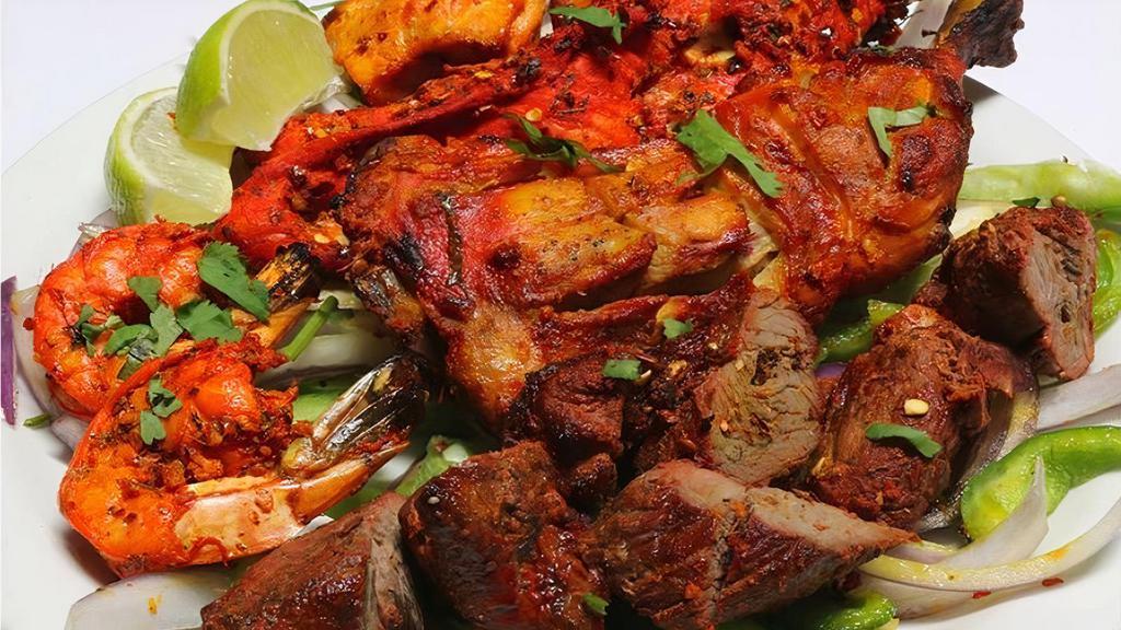 Tandoori Mix Grill · A combination platter consisting of chicken tandoori, chicken tikka, lamb tikka, salmon tikka and tandoori shrimp.