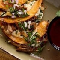 Tacos Birria Quesatacos · Three per order. Queso Oaxaca, cilantro, onions, consommé dip, corn tortilla. . Gluten-Free