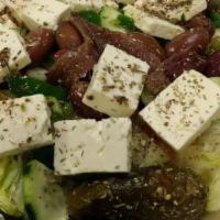 Greek Salad · Greek feta, anchovies, black olives, lettuce, tomato and stuffed grape leaves (dolmades). Ad...