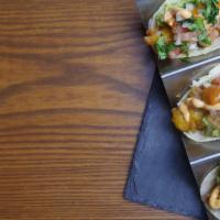 Fish Tacos · Three breaded baja fish tacos, homemade corn tortilla, guacamole, pico de gallo, cabbage and...