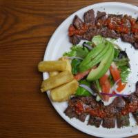 Skirt Steak · Grilled marinated skirt steak, fried yucca and house salad with avocado.