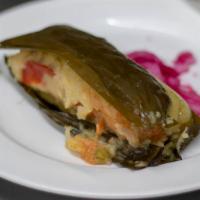 Tamales Centro Americano - Antojitos · Central American style Tamal stuffed with pork or chicken, wrapped in a green banana leaf.