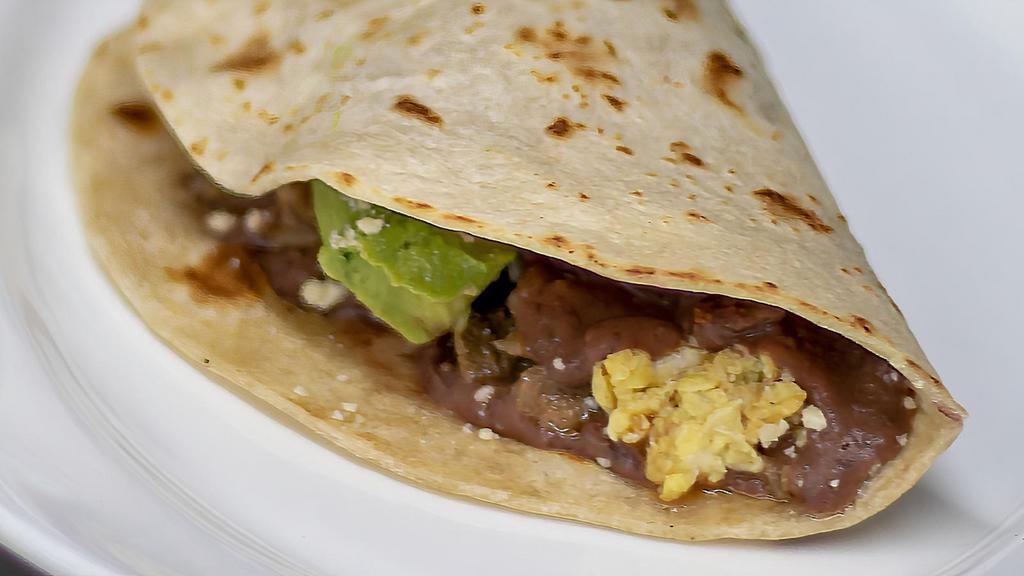 Baleada!: Baleada Con Todo · Baleada stuffed with a choice of meat, mashed refried beans, crema, crumbled cheese, eggs and avocado.
Con Todo - Huevo, Aguacate, Frijoles, Queso, Crema, y Carne