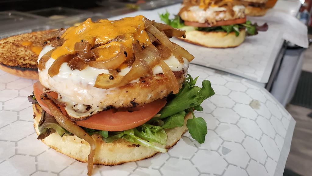 Alaskan Goddess · Wild Alaskan salmon, one of !Craves most desirable burgers and absolutely delicious! Served on a toasted brioche bun, lettuce, tomato, grilled onions, white american cheese and chipotle sauce.