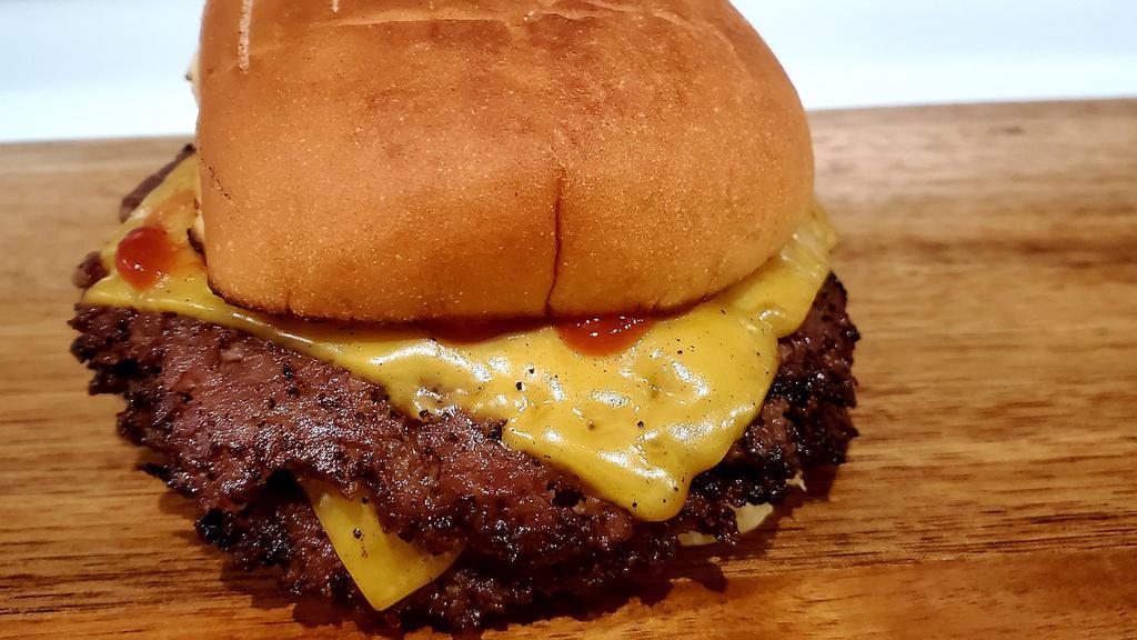 Smashup Cheeseburger · 2 thinly smashed Angus ground beef seared on the grill on a toasted potato bun with yellow American cheese and our house sauce!! a classic American favorite!!